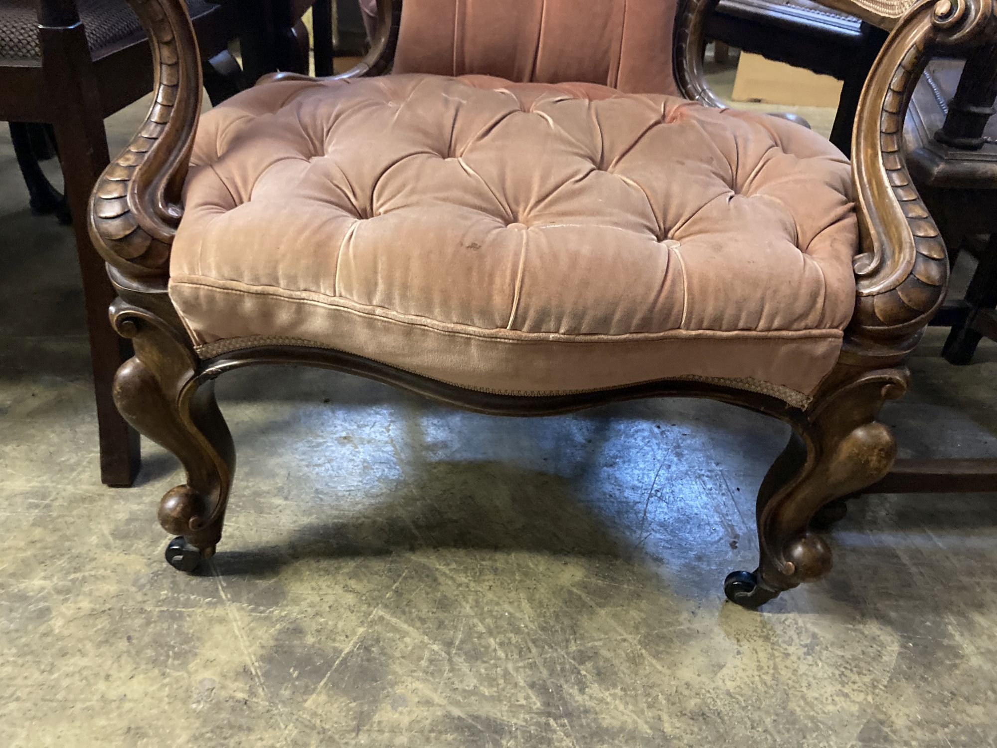 A Victorian carved walnut upholstered spoon back armchair, width 75cm, depth 70cm, height 102cm
